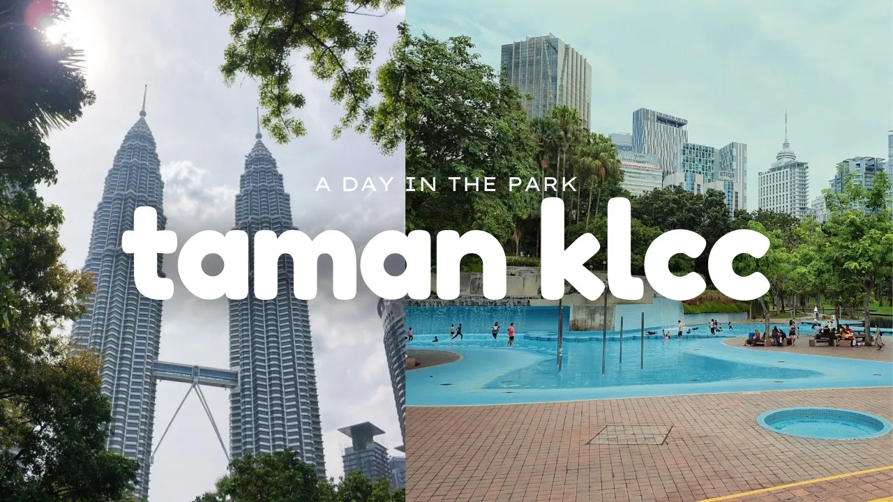 The Petronas Towers framed by trees and the blue wading pool in Taman KLCC.